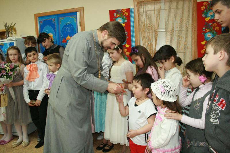 о.Анатолий вручает детям подарки